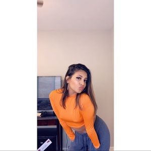 orange cropped long sleeve shirt